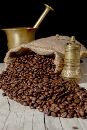 fresh roasted  coffee beans and brass cup の写真素材