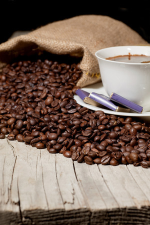 Coffee cup with burlap sack of roasted beansの写真素材