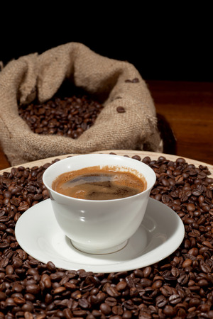 Coffee cup with burlap sack of roasted beans の写真素材