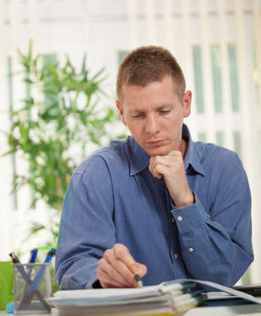 focused businessman studying plansの写真素材