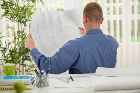 businessman analyzing graphs in his officeの写真素材