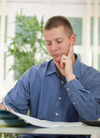 focused businessman studying plansの写真素材