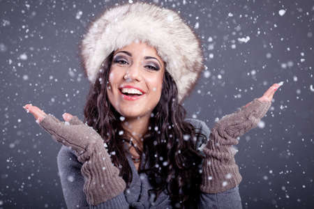 young attractive woman over snowy Christmas backgroundの写真素材