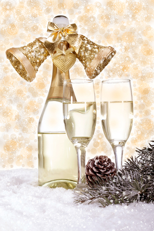 Champagne in glasses and gift box on golden backgroundの写真素材