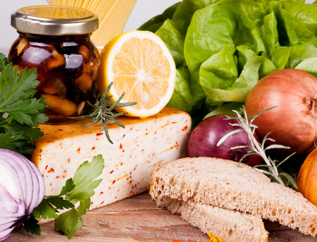 cheese,onion and fresh herbs on wooden backgroundの写真素材
