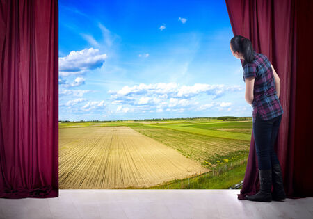 young woman in magic scene open curtainの写真素材