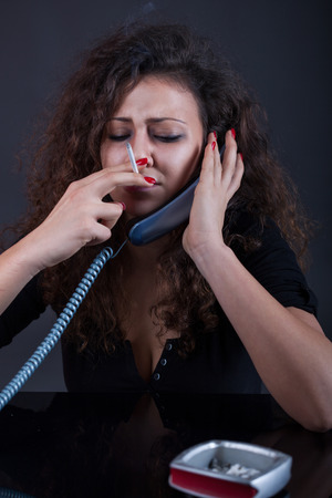 depressed young crying girl with a cigarette in his hand ask for help to via sauce Centerの写真素材