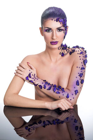 Beauty  portrait of beautiful woman model face with magic creative fashion purple make-upの写真素材
