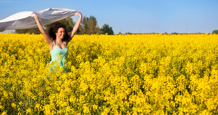 Woman with white piece of cloth in windの写真素材