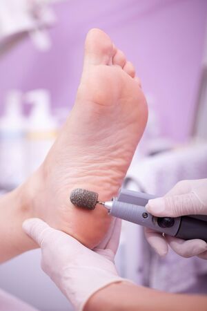 Peeling feet pedicure procedure in a beauty salonの写真素材
