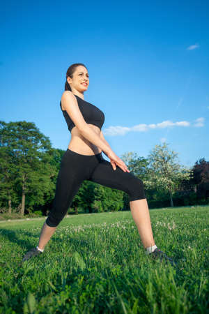 Young woman stretching in parkの写真素材