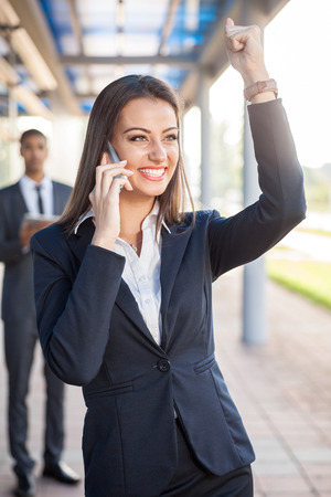 Successful business woman receiving good news over the Cell phoneの写真素材