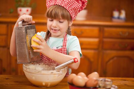 funny young child making mess in kitchenの写真素材