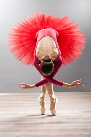 Ballerina is wearing a red tutu and pointe shoesの写真素材
