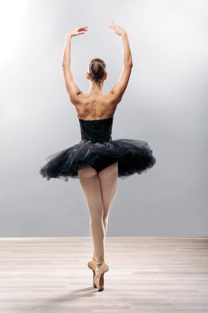 Ballerina is wearing a black tutu and pointe shoesの写真素材
