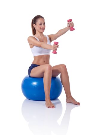 pretty young woman exercising with dumbbellsの写真素材