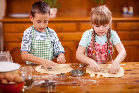 happy children playing chef in the kitchenの写真素材