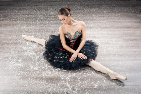 Ballerina is wearing a black tutu and pointe shoesの写真素材