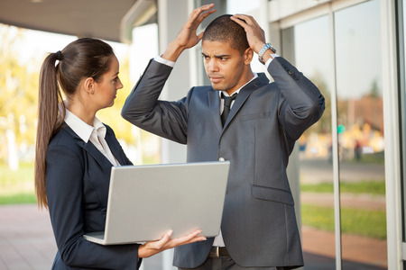 businessmen receiving bad news outdoorの写真素材