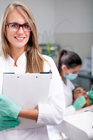 Dentist doctor smiling in cameraの写真素材