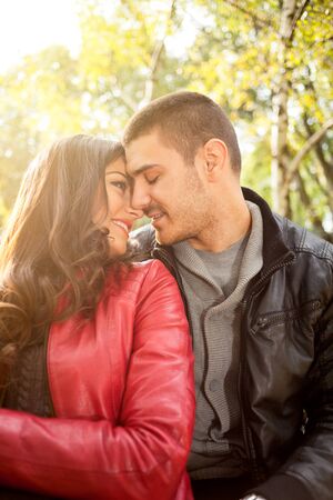 happy young couple ejoying the autumn in parkの写真素材