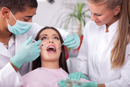 Dentist male preparing a syringe to anesthetize his patientの写真素材