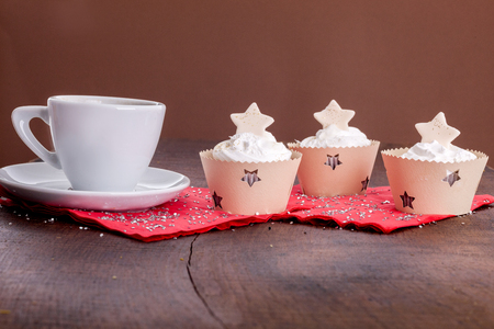 Holiday decorated cupcakes on wooden backgroundの写真素材