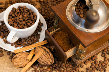 coffee beans and old coffee mill on the wooden backgroundの写真素材