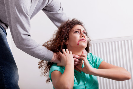 drunken husband strangles his wife with handsの写真素材