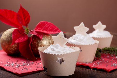 Holiday decorated cupcakes on wooden backgroundの写真素材
