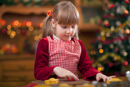 girl baking in kitchen Christmas cakesの写真素材