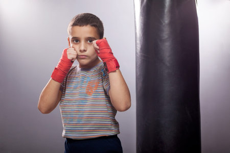 serious young child boxer posing