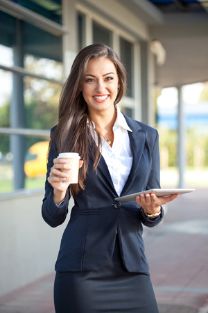 Business woman using tablet pc outsideの写真素材