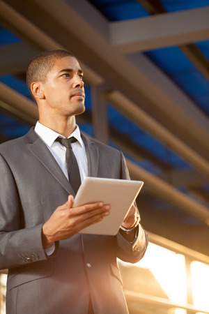 Successful business man with digital tablet outsideの写真素材