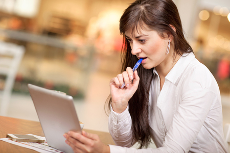 caucasian business woman in coffee break workingの写真素材