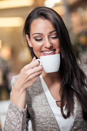 businesswoman drinking coffee in a cafeの写真素材