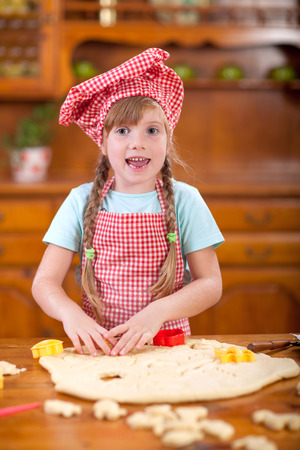 smiling girl make a mess in the kitchenの写真素材