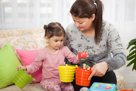 happy kid girl and mom playingの写真素材