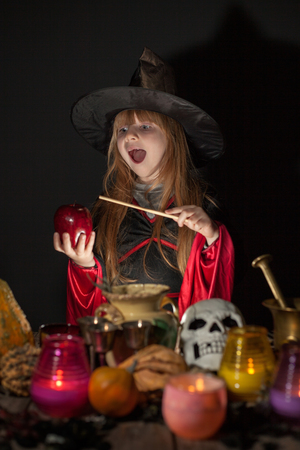 Halloween. cheerful little witch with a magic wandの写真素材