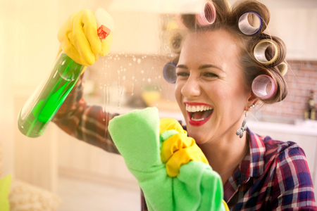 cleaning window pane with spray detergent, spring cleaning conceptの写真素材