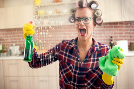 cleaning window pane with spray detergent, spring cleaning concept
