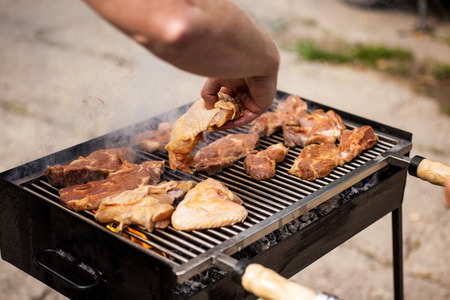 some meat being grilled in a barbecueの写真素材