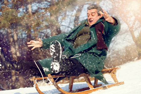 senior Man with Sled out in a Snow Stormの写真素材