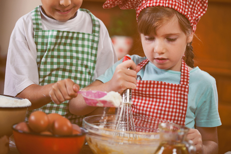 beautiful caucasian child making a cake, smiling happyの写真素材