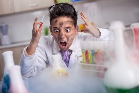 Explosion in the laboratory,funny crazy scientist boy working in a laboratoryの写真素材