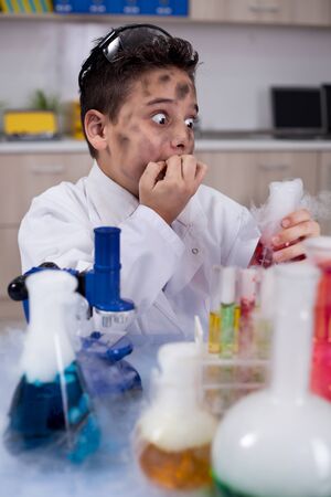 little schoolboy working in chemistry labの写真素材