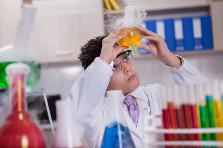 schoolboy scientist holding sample in special laboratoryの写真素材