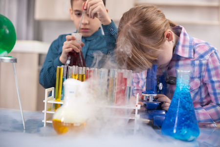 girl and boy doing experiments in the laboratory,Science and education conceptの写真素材
