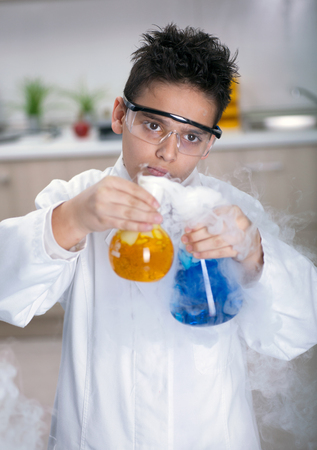 schoolboy scientist holding sample in special laboratoryの写真素材