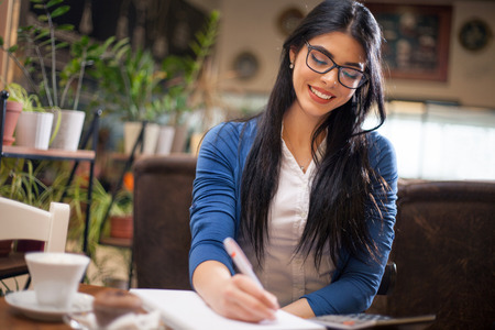 young beautiful woman sitting in restaurantの写真素材